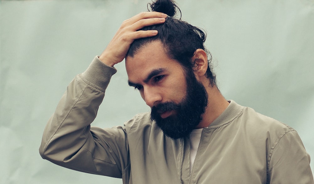 A man massaging a treatment into his scalp